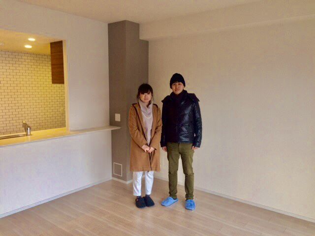 東京都武蔵村山市のご入居中戸建てで施工後のLDKに立つご夫婦（シリコンフロアコーティング施工後）