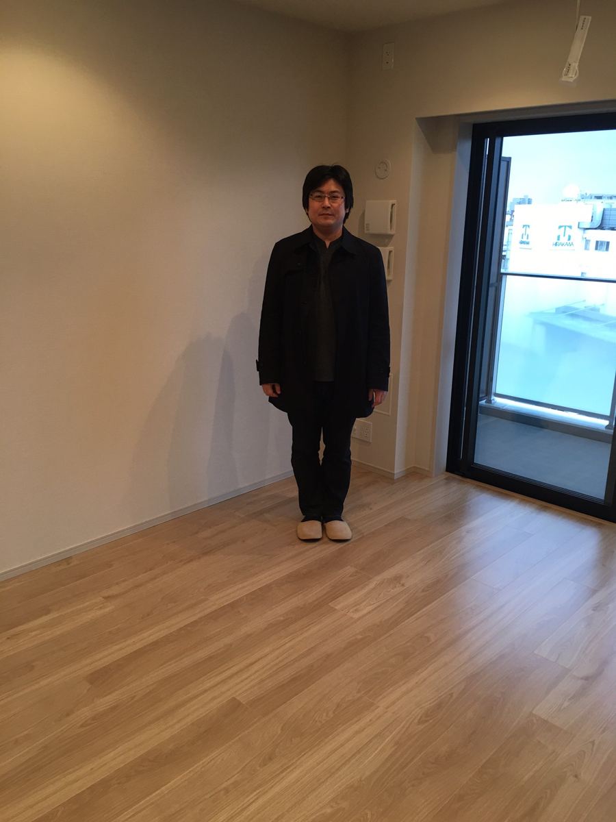 東京都中野区のご新築マンションで施工後の床とお客様(水性ウレタンフロアコーティング施工後)