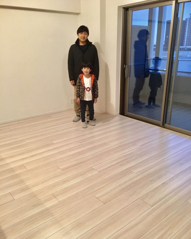 東京都世田谷区のご新築マンションで施工後の床とお客様（水性ウレタンフロアコーティング施工後）